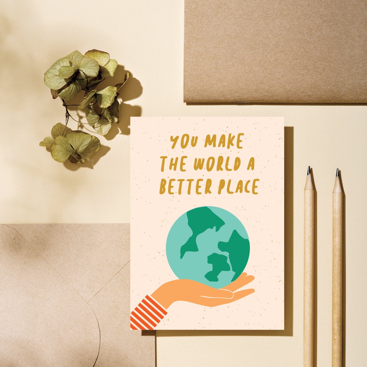 greeting card with earth on the palm of a hand with a text that says you make the world a better place