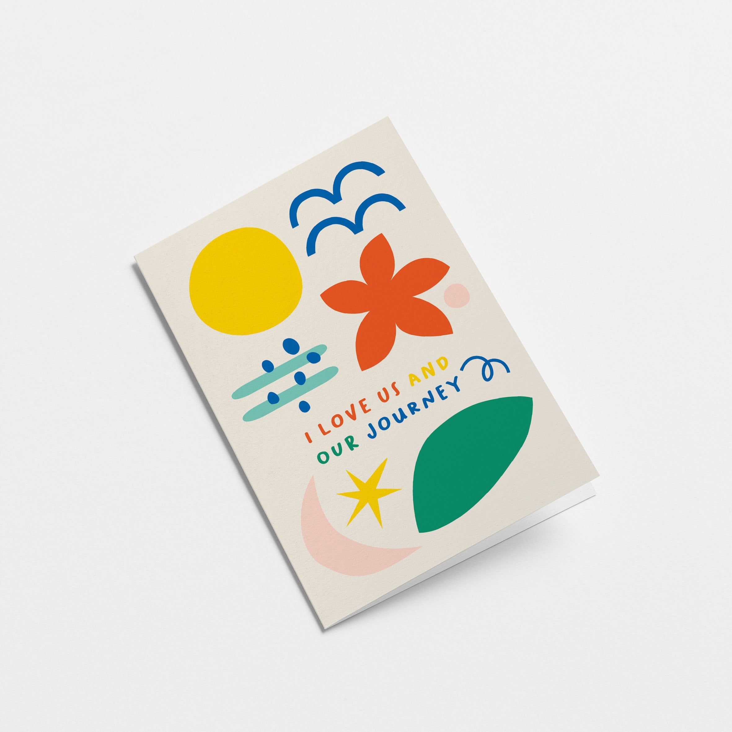 Love card with yellow sun, blue birds, red flower, green, pink, blue and yellow figures and a text that says I love us and our journey