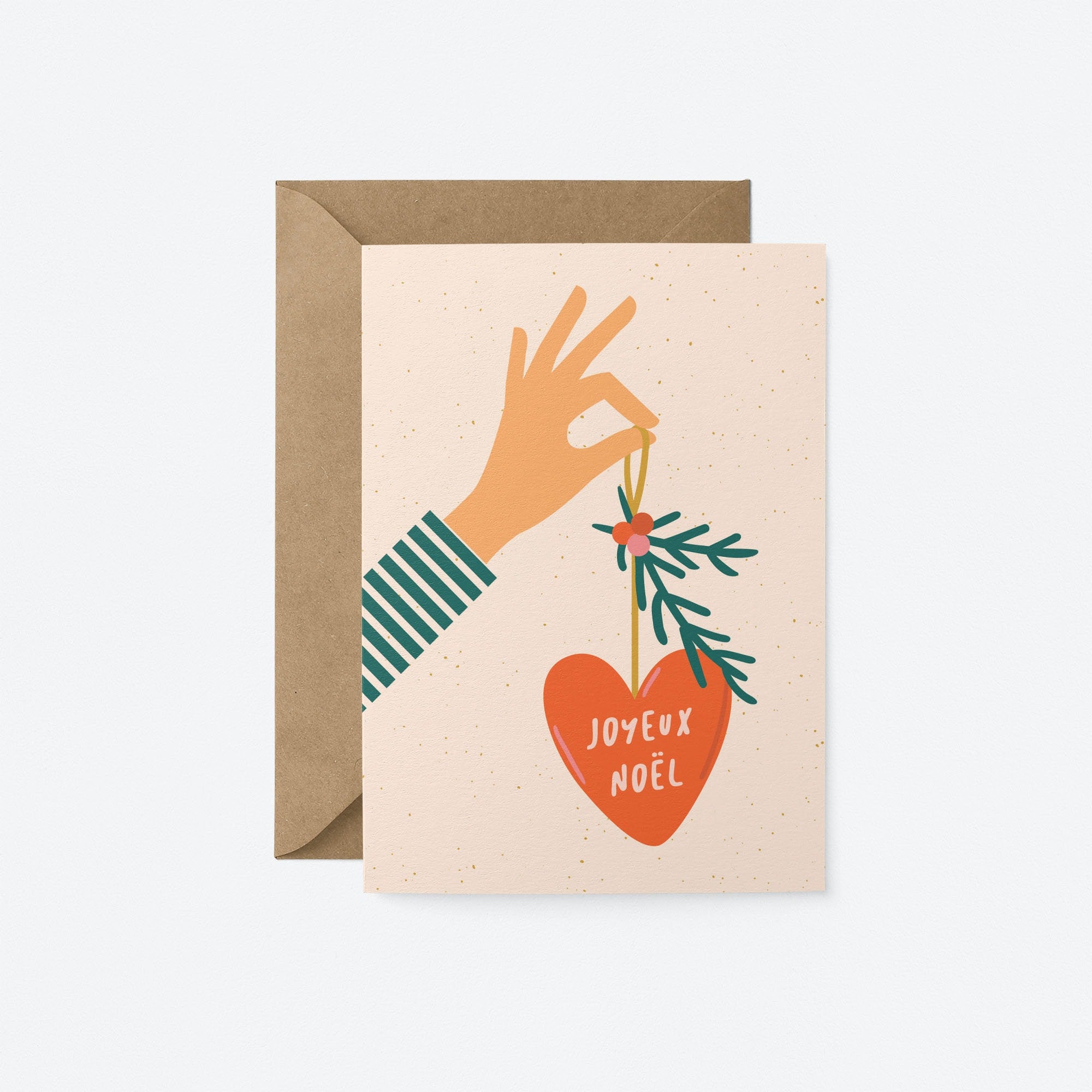 christmas card with a hand holding red christmas tree ornament and a text in it that says be merry and bright