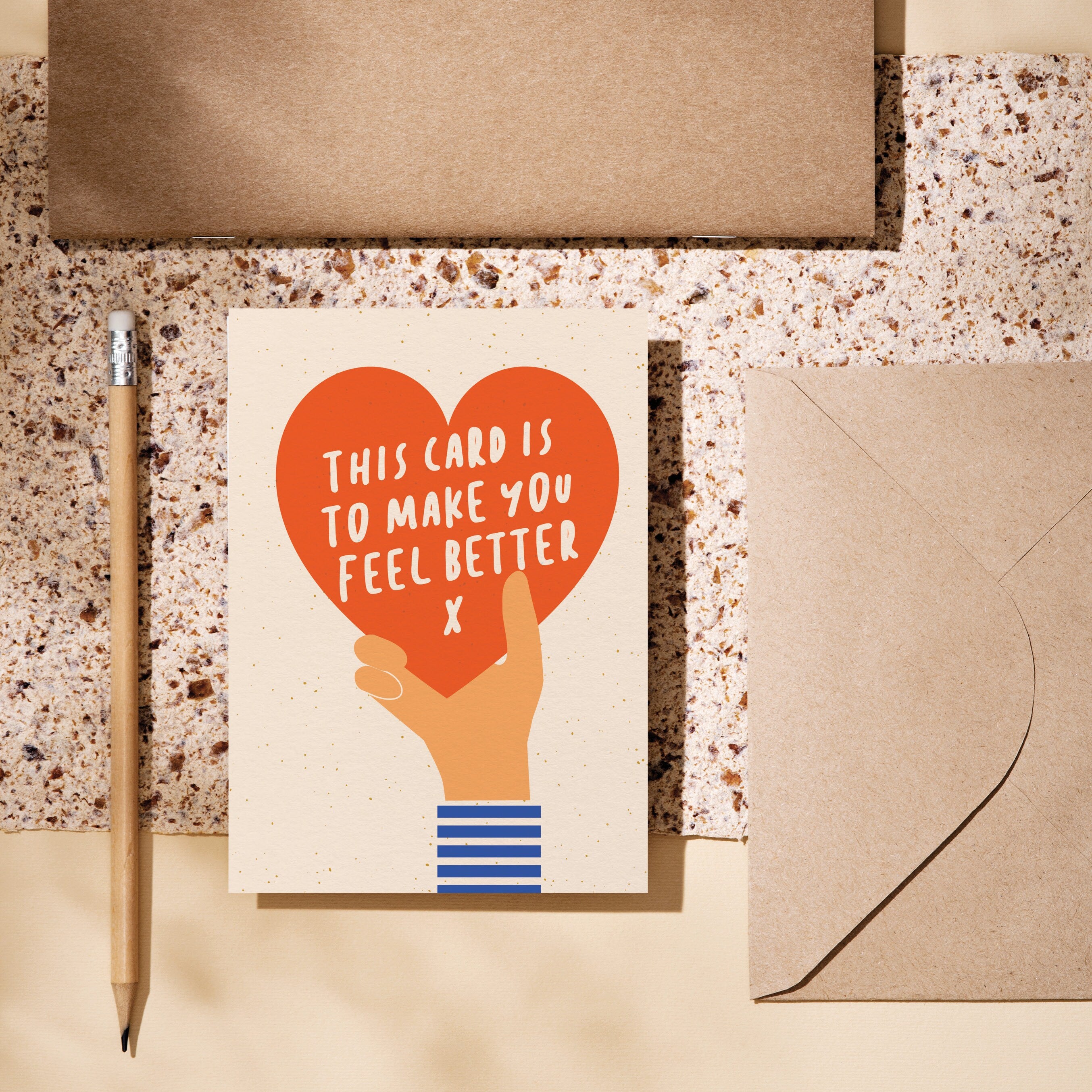 greeting card with a hand holding red heart and a text inside the heart that says this card is to make you feel better