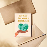 friendship card with a heart shaped earth on the palm of a hand with a text you make the world a better place