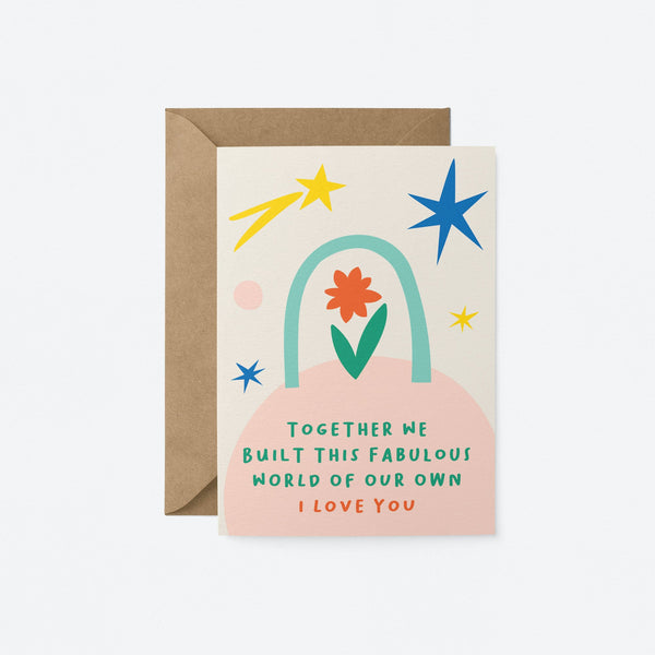 Love card with red and green flower, blue, yellow and pink figures with a text that says together we built this fabulous worlf of our own i love you