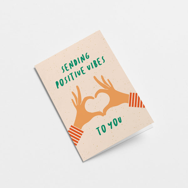 greeting card with two hands creating heart shape with fingers and a text that says sending positive vibes to you