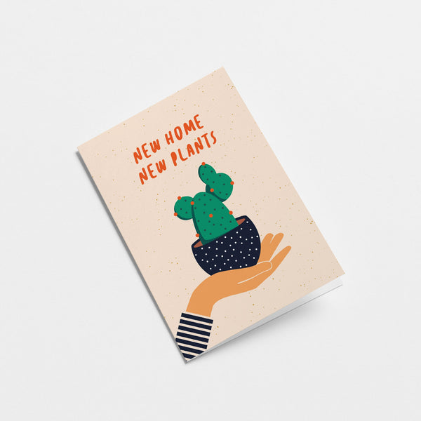 housewarming card with a hand holding a black flowerpot with a cactus in it and a text that says new home new plants