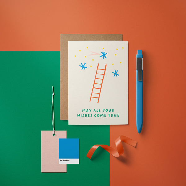 Birthday card with a red ladder and blue stars and a text that says May all your wishes come true
