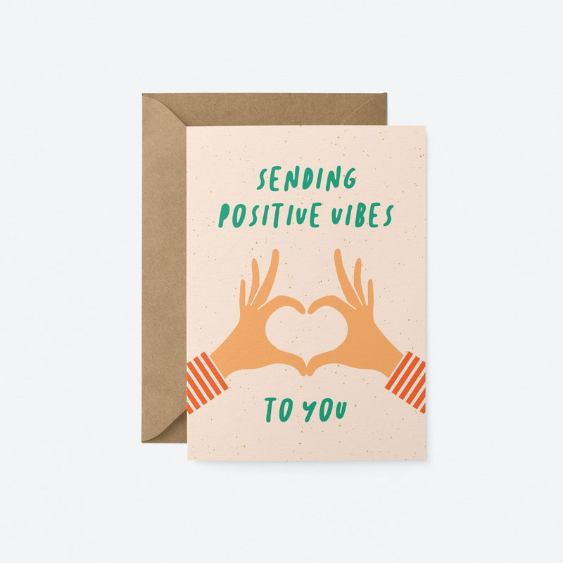 greeting card with two hands creating heart shape with fingers and a text that says sending positive vibes to you