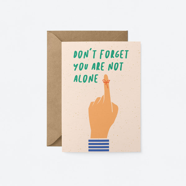 friendship card with a finger tied with a red string with a text that says don’t forget you are not alone