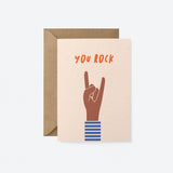 birthday card with a brown hand and a gesture of sign of the horns with a text that says you rock