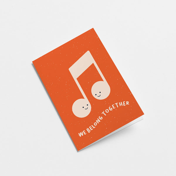 Love greeting card with musical note and a text that says we belong together