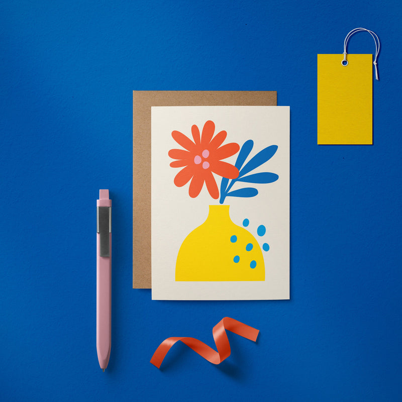 Greeting card with red and blue flowers and yellow vase