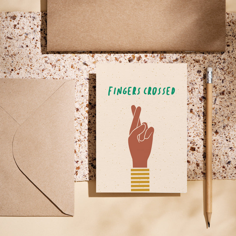 Good luck card with brown fingers crossed hand gesture and a text that says fingers crossed