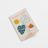 new baby card with green leaf drawings and a little red leaf with yellow sun and a text that says your family is growing