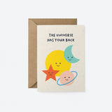 Everyday greeting card with a yellow sun, blue crescent moon, red star and pink planet and a text that says the universe has your back