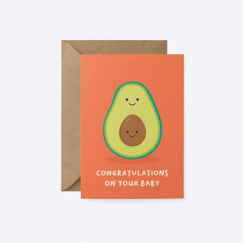New baby greeting card with a green avocado and a its brown seed as a baby and a text that says congratulations on your baby