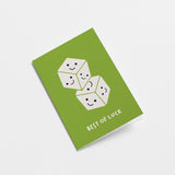 Good Luck card with two white dices on top of each other with smiley faces in each face and a text that says best of luck