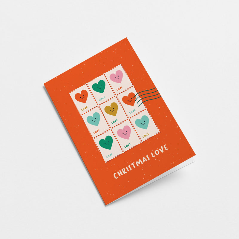 christmas greeting card with colorful heart shaped letter stamps and a text that says christmas love