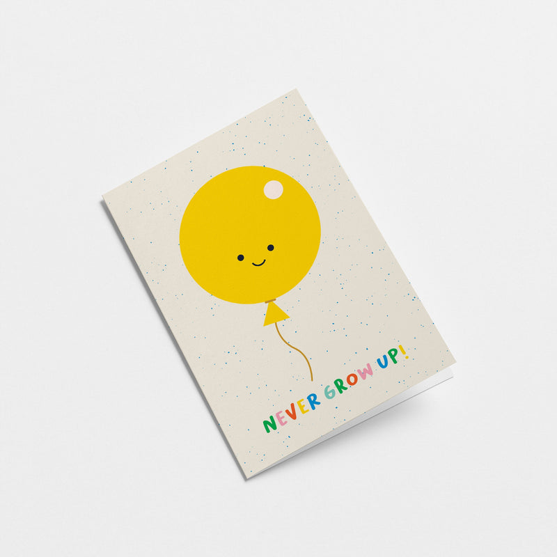 birthday card with A yellow balloon with smiley face and a text that says never grow up