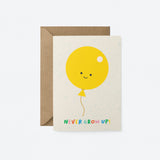 birthday card with A yellow balloon with smiley face and a text that says never grow up
