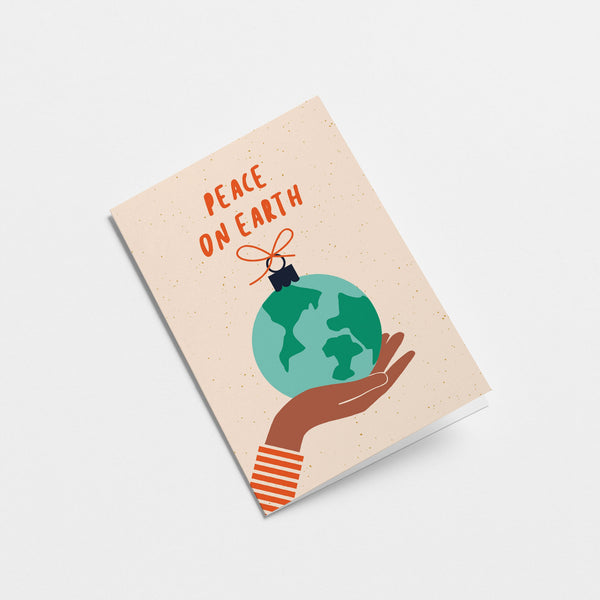 greeting card with gift wrapped earth on the palm of a brown hand with a text that says peace on earth