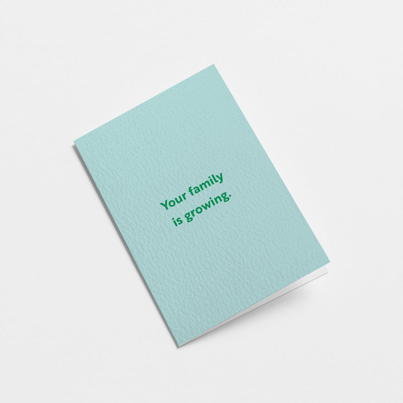 new baby card with a text that says your family is growing