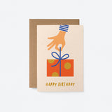 Birthday card with a hand holding a gift box from above with a text that says happy birthday
