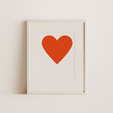 a big red heart print with white frame.
